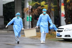 Medical staff carry a box as they walk at the Jinyintan hospital, where the patients with pneumonia caused by the new strain of coronavirus are being treated, in Wuhan, Hubei province, China January 10, 2020. Picture taken January 10, 2020. REUTERS/Stringer CHINA OUT